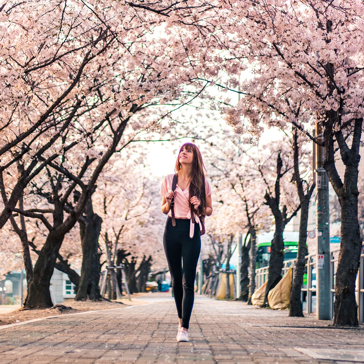 Woman walking through blossoms